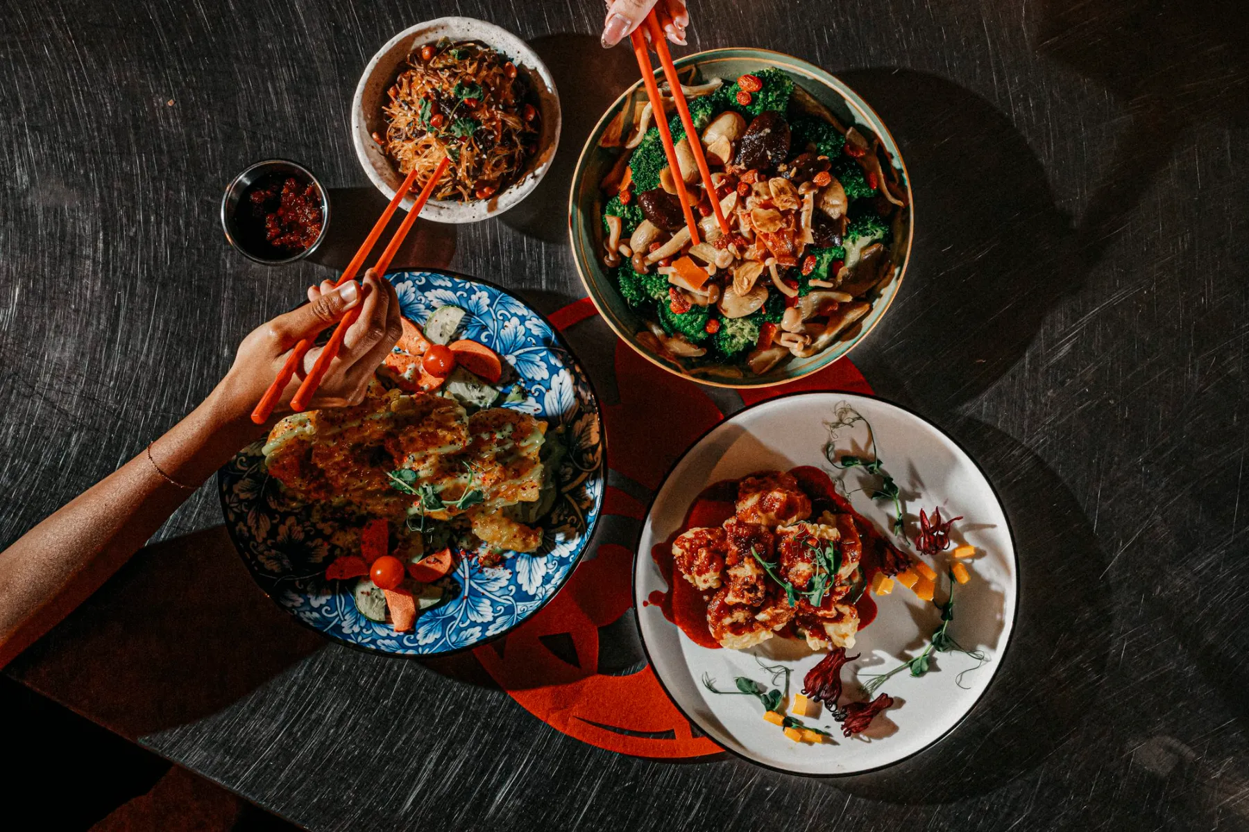 Chinese New Year dishes shared on a festive table by Four Seasons Catering