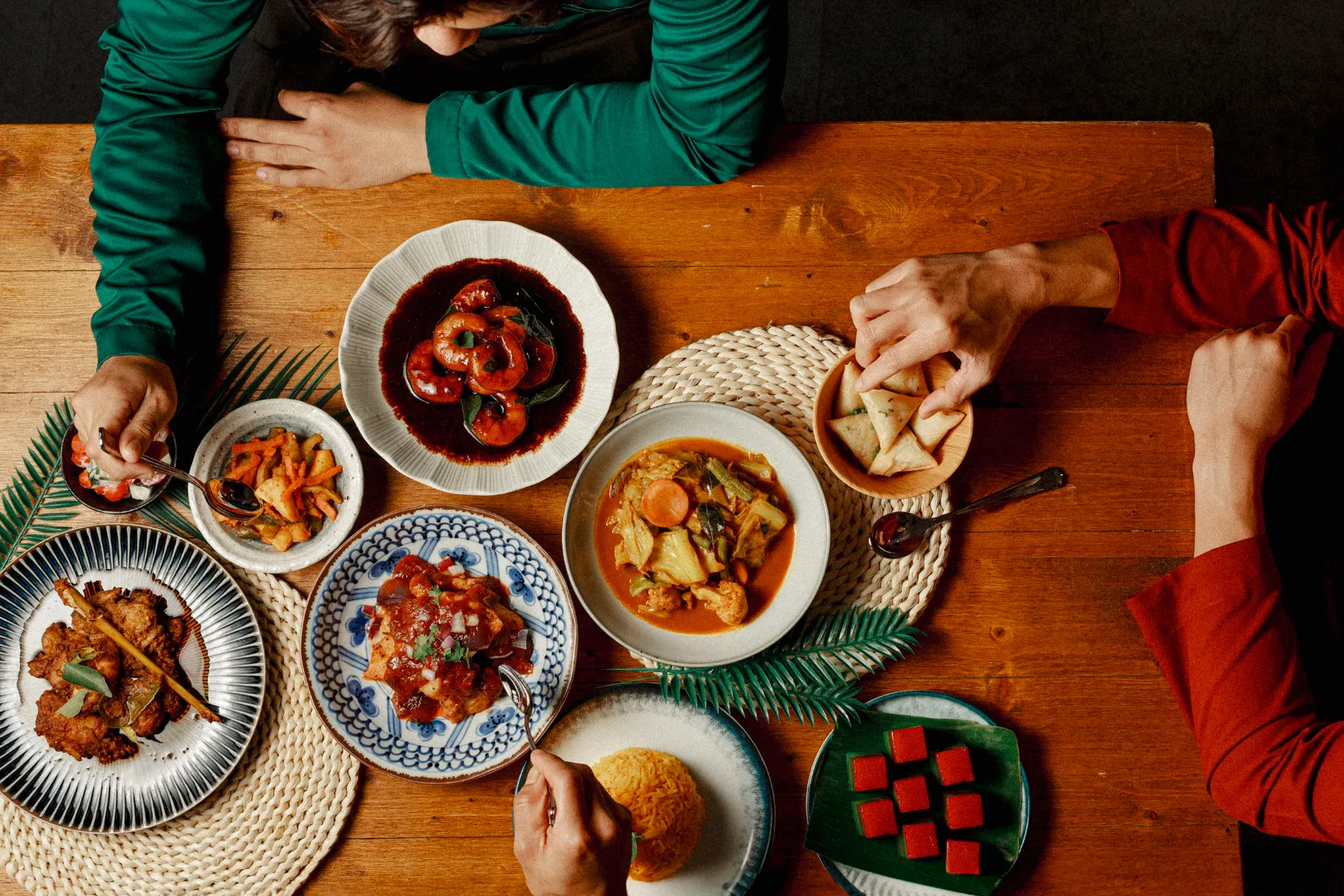 Hari Raya dishes shared around a table by Four Seasons Catering